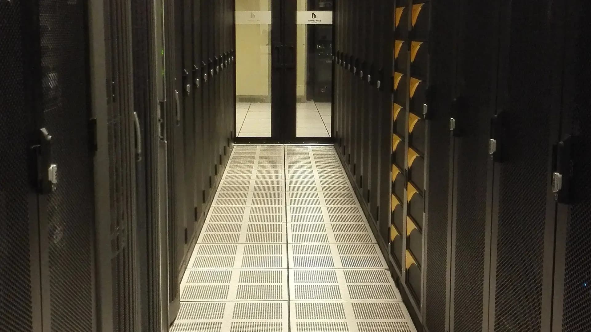 An aisle of server racks in a professionally managed data centre